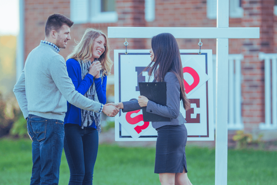 Image shows a couple buying a house